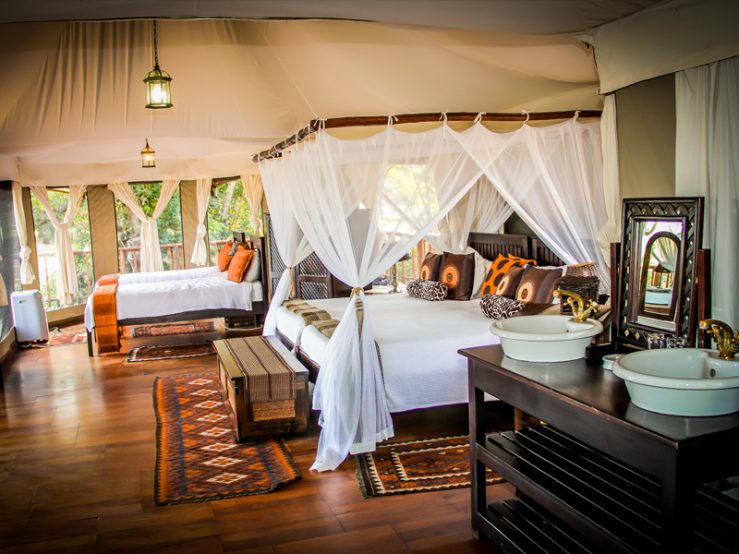 Luxury tented suite with canopy beds in Serengeti on 8-Day Northern Circuit Safari in Tanzania