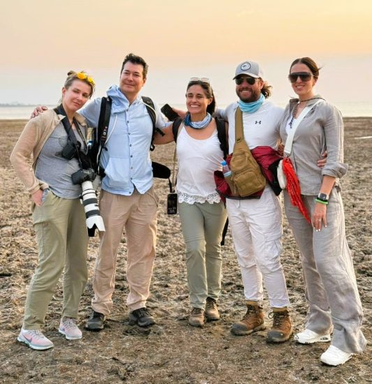 Private safari Tanzania - private group tour guests enjoying sunset in Serengeti National Park