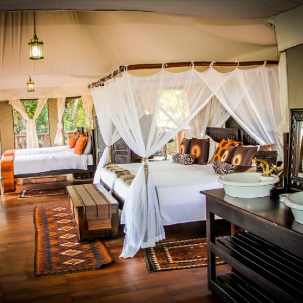 Luxury tented suite with canopy beds in Serengeti on 8-Day Northern Circuit Safari in Tanzania